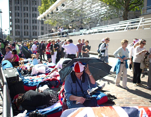 Royal supporters sit by a fence in central London on April 27, 2011. 