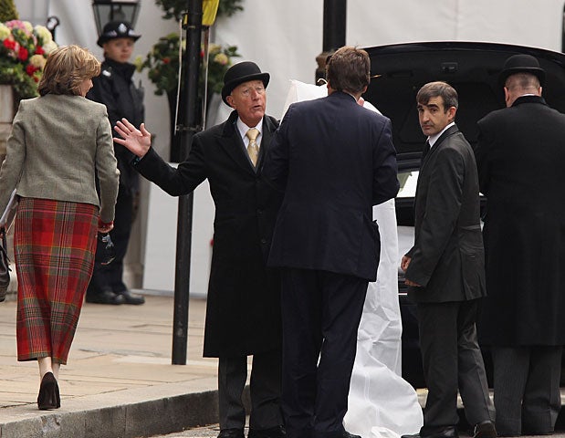 Hotel staff help guests as they arrive at the Goring Hotel, where Kate Middleton will spend her last night as a unmarried woman, ahead of the royal wedding on Friday morning. 