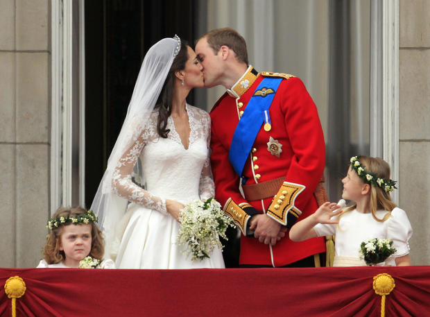 Britain's Prince William kisses his wife Kate, Duchess of Cambridge on the balcony of Buckingham Palace after the Royal Wedding in London Friday, April, 29, 2011.  