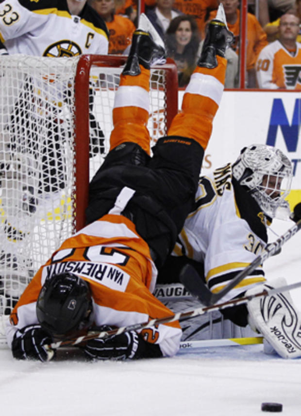 Flyers' James van Riemsdyk tumbles over Bruins goalie Tim Thomas 