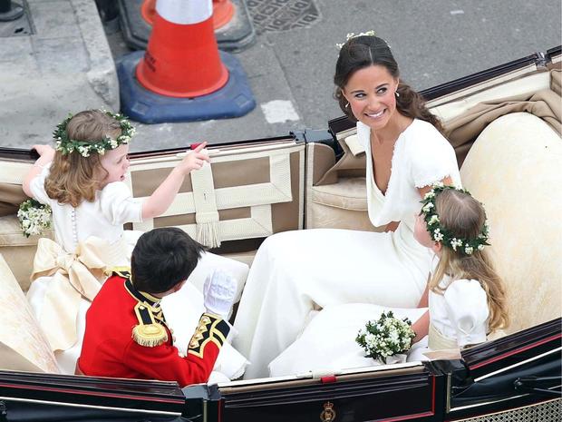 LONDON, ENGLAND - APRIL 29: Maid of Honour Pippa Middleton with brides maids and page boy make the journey by carriage procession to Buckingham Palace following their marriage at Westminster Abbey on April 29, 2011 in London, England. The marriage of the  