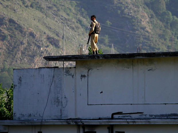 A Pakistan army soldier stands on top of the house where it is believed al-Qaida leader Osama bin Laden lived in Abbottabad, Pakistan 