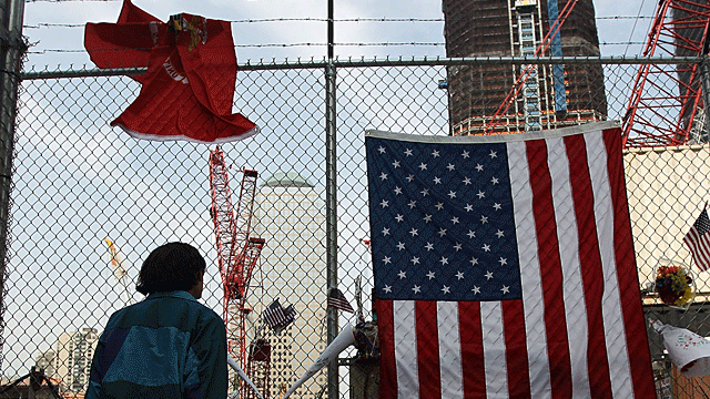 A man views construction at the World Trade Center site as the new One World Trade Center rises behind after the death of accused 9/11 mastermind Osama bin Laden May 3, 2011 