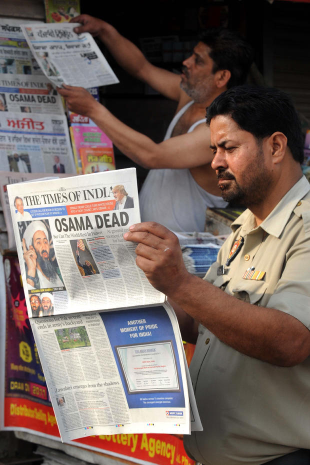 An Indian Punjab Police man reads a newspaper 
