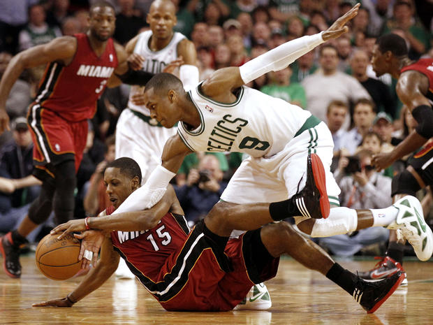 Boston Celtics' Rajon Rondo  uses his right arm to try to steal the ball from Miami Heat's Mario Chalmers  
