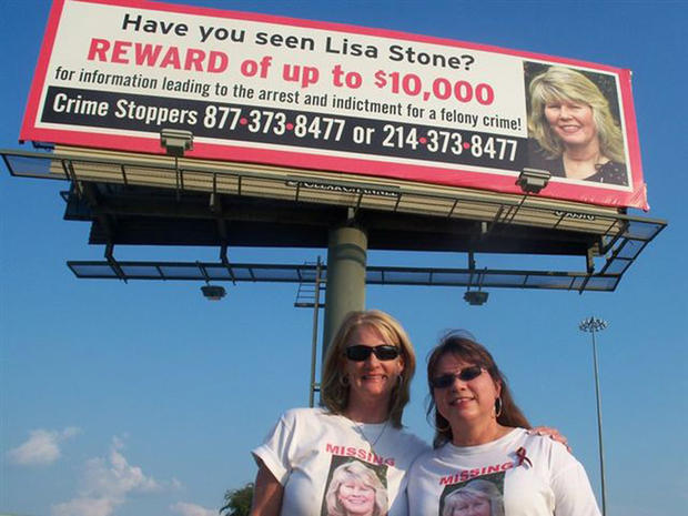 Joni Shannon and Tina Wiley stand in front of the billboard to help find their friend, Lisa Stone. 