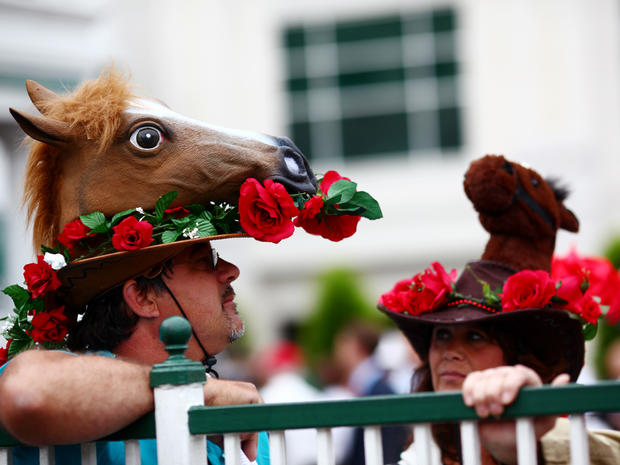 Two racing fans display their Derby hats near the paddock at Churchill Downs before the 137th running of the Kentucky Derby in Louisville, Ky., on May 7, 2011.  