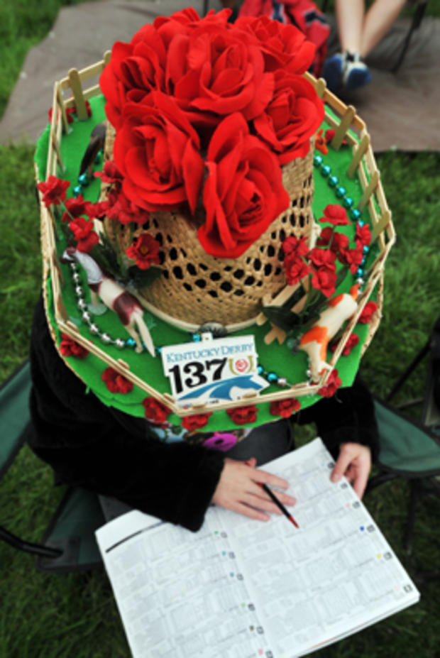 Gabriella Sawicki studies a race program for the 137th Kentucky Derby horse race at Churchill Downs Saturday, May 7, 2011, in Louisville, Ky. 