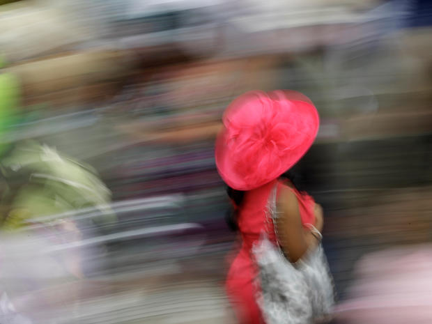 A woman walks near the paddock before the 137th Kentucky Derby horse race at Churchill Downs, Saturday, May 7, 2011, in Louisville, Ky.  