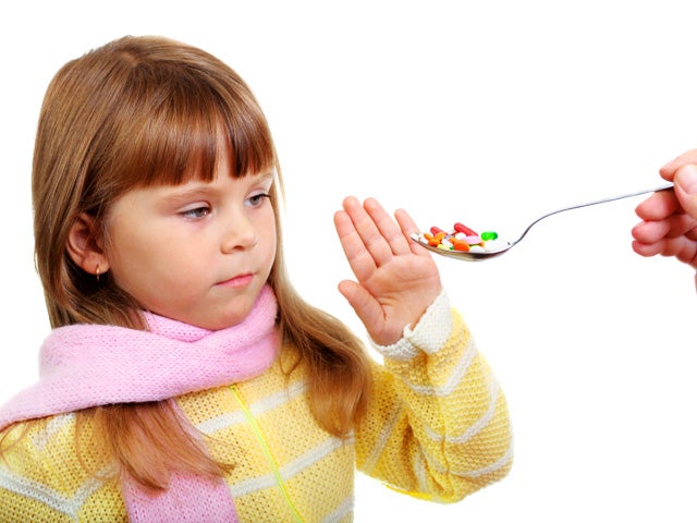 Pills of many shapes and colors grouped together  