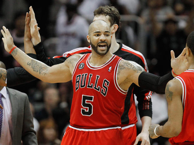Carlos Boozer reacts to a goal with teammates  