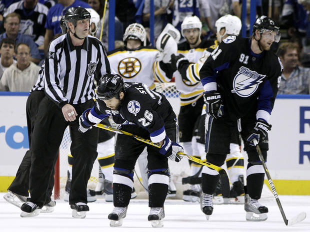 Martin St. Louis and  Steven Stamkos react as members of the Boston Bruins celebrate 