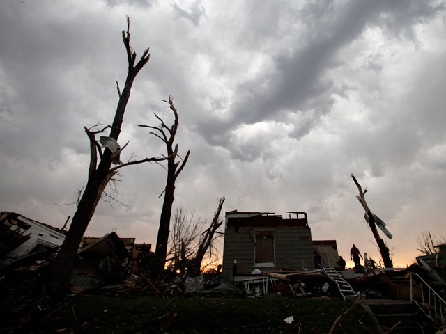 Residents salvage items from their home 
