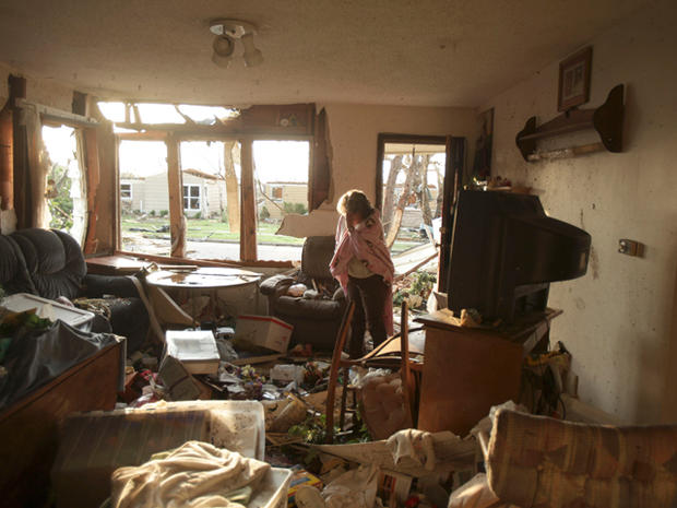 Jean Logan reacts as she sees the damage to her home 