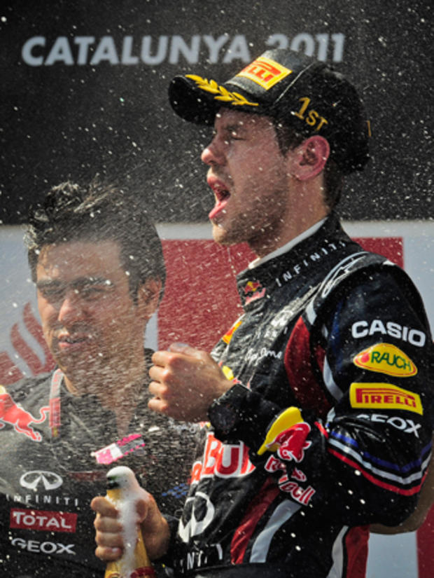 Sebatian Vettel celebrates with champagne 