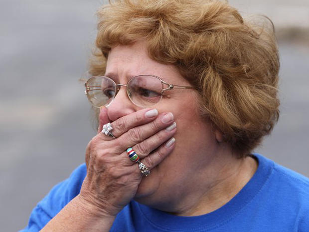Landlord Sandy Snodgrass reacts after seeing the destroyed apartment complex for the first time since the tornado.  