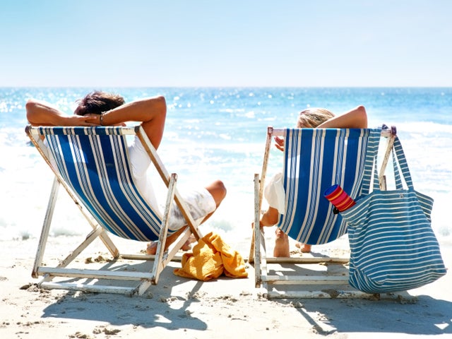 couple sitting on deck chairs  