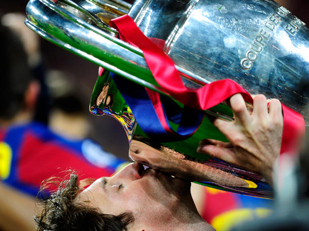  Lionel Messi celebrates with the trophy  