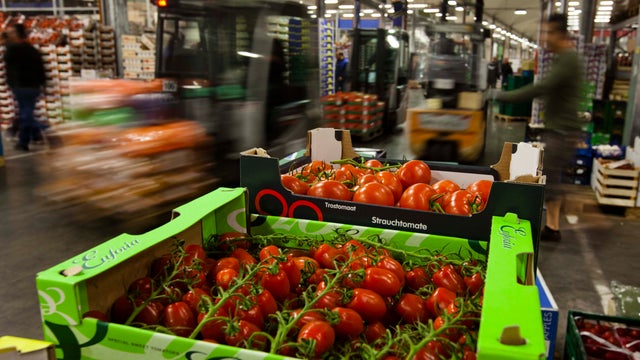 Forklifts drive between pallets with vegetables and fruits in Berlin 