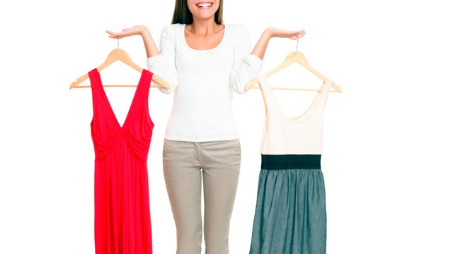 Woman choosing between dresses  