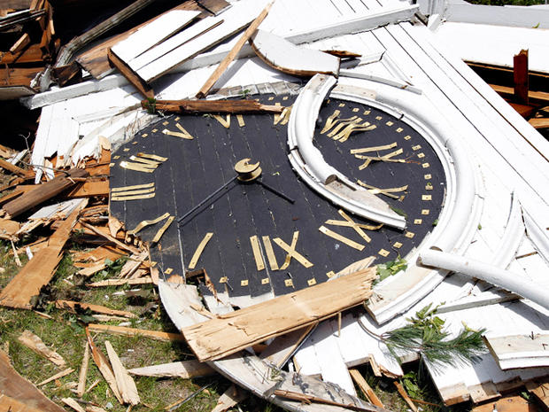 The clock from the steeple of The First Church of Monson lay in rubble 