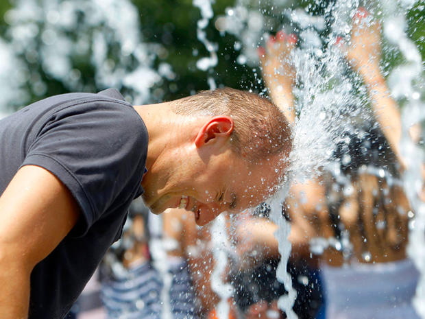 man cools off in a fountain  