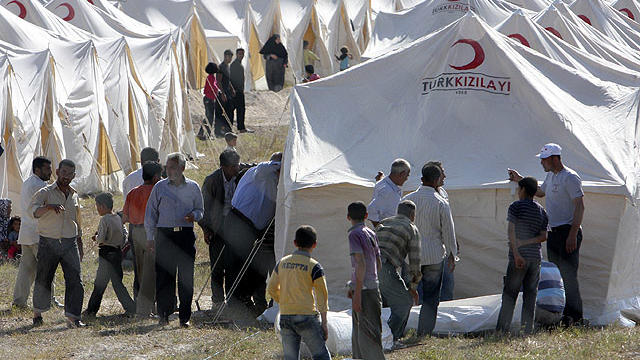 Syrian refugees are seen in a tent compound in Boynuyogun, Turkey, near the Syrian border, June 13, 2011.  