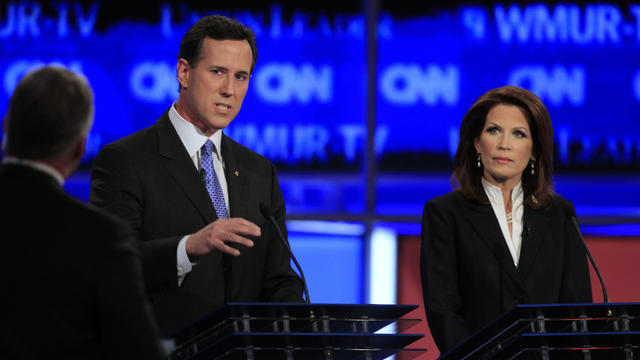 Former Pennsylvania Sen. Rick Santorum, center, answers a question asked by CNN's John King, left, as Rep. Michele Bachmann, R-Minn., right, listens during the first New Hampshire Republican presidential debate at St. Anselm College in Manchester, N.H. 