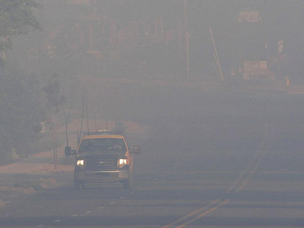 A truck drives along the street as smoke from the Las Conchas fire fills the air in Los Alamos, N.M., June 30, 2011.  