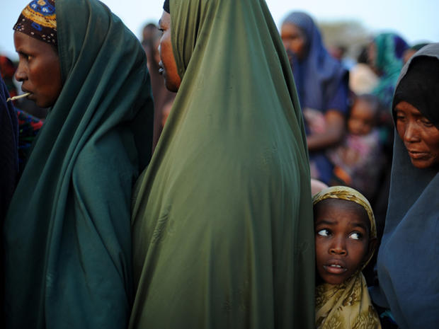 Somali girl stands in line outside a food distribution point 