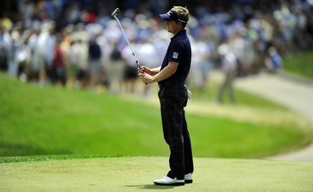 Luke Donald of England reacts after miss 