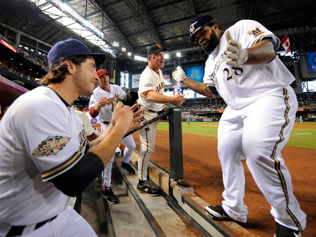 Prince Fielder  is congratulated by manager Bruce Bochy and Ryan Braun 