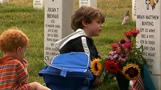 Cooper and Connor Bunting visit the gave of their father at Arlington National Cemetery.  