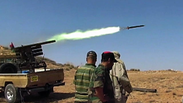 60 miles outside of Tripoli, Libyan rebels return fire to Qaddafi forces.   