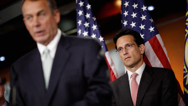 House Majority Leader Eric Cantor (R-VA) listens to Speaker of the House John Boehner (R-OH) during a news conference 