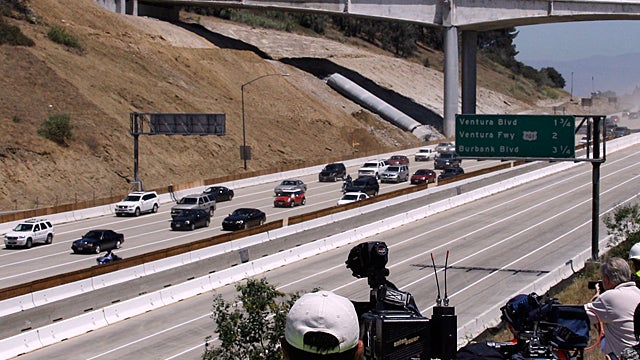 The California Highway Patrol leads the first vehicles on southbound Interstate 405  