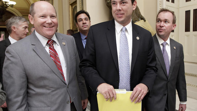 Rep. Reid Ribble, R-Wis., left, Rep. Jason Chaffetz, R-Utah, center, and other House Republicans, smile after passage of a conservative deficit reduction plan 