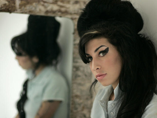 British singer Amy Winehouse poses for photographs after being interviewed by The Associated Press  