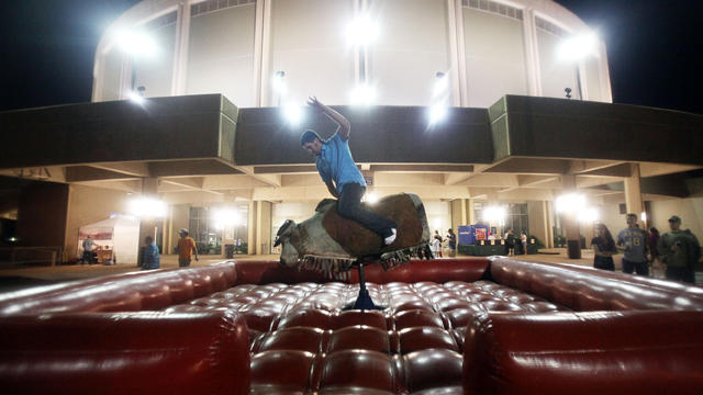 Aaron Erskine rides a mechanical bull at the Biloxi Crawfish Festival on the Gulf Coast April 15, 2011, in Biloxi, Miss. BP says it has made tourism payments of $18 million to Mississippi in an attempt to help draw tourists back to its beaches following 2 