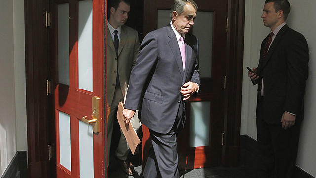 House Speaker John Boehner of Ohio emerges from a closed-door caucus with House Republicans as work continues to avert a default, July 27, 2011, on Capitol Hill in Washington.  