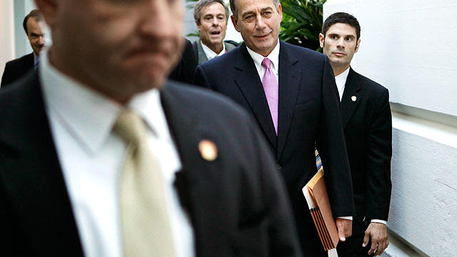 Speaker of the House John Boehner (R-OH), surrounded by plainclothes police officers, arrives for a House GOP caucus meeting at the U.S. Capitol July 27, 2011 in Washington, DC.  