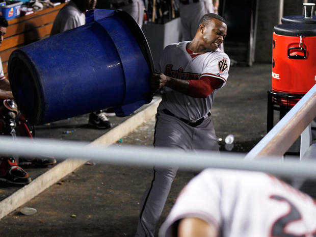 Justin Upton throws a recycle trash can in the dugout  