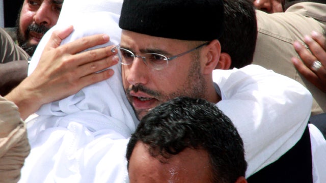 Seif al-Islam Qaddafi, son of embattled Libyan leader Muammar Qaddafi, embraces his brother Mohammad during the funeral of their brother Seif al-Arab Qaddafi at the Al-Hani cemetery in Tripoli, Libya, May 2, 2011, after the 29-year-old was killed along wi 