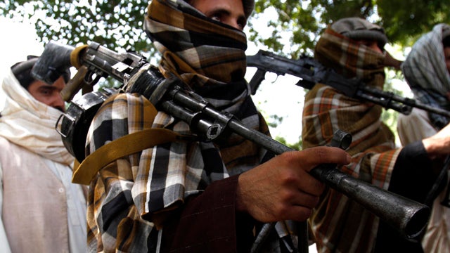 Taliban fighters hold their heavy and light weapons before surrendering them to Afghan authorities in Jalalabad, Afghanistan, July 31, 2011. Around 20 Taliban fighters laid down their weapons at a ceremony as part of a peace-reconciliation program in Jala 