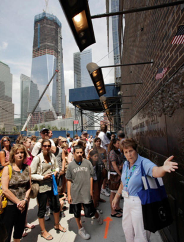 Tracy Gazzani, right, leads a walking tour past the Fire Department of New York Memorial Wall adjacent to the World Trade Center site in New York  