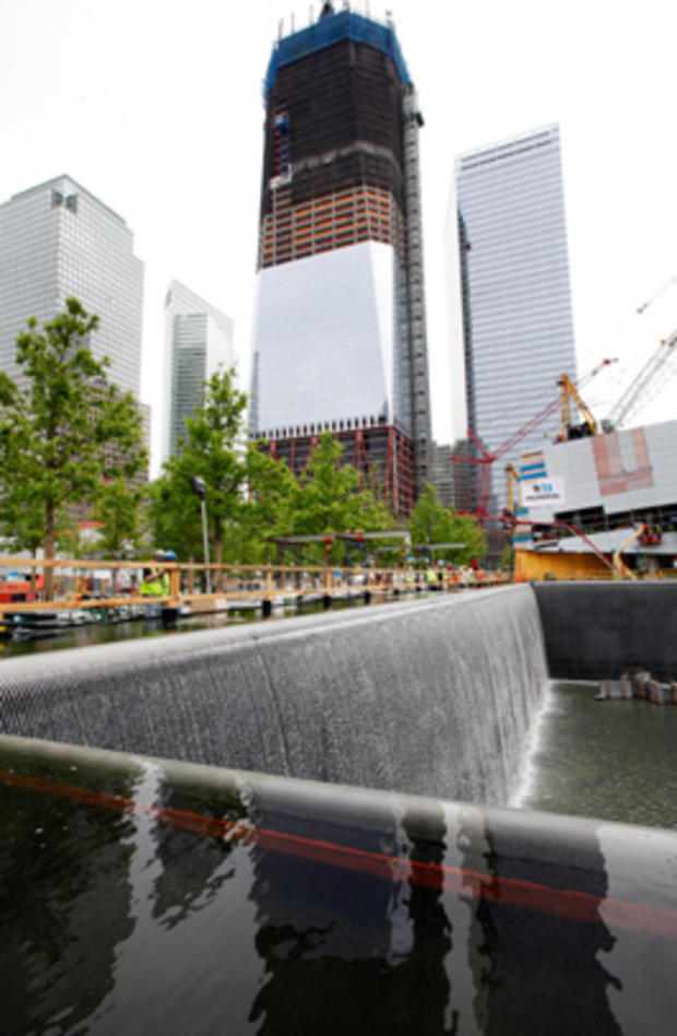 Waterfalls empty into a massive reflecting pool at the National September 11 Memorial in New York  