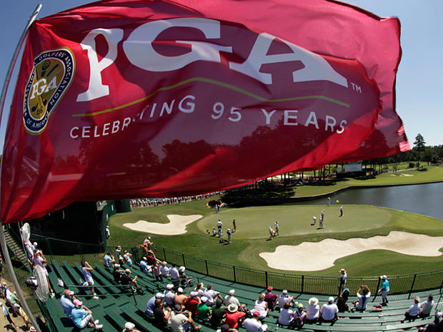 A flag flies over the stands on the 18th hole 