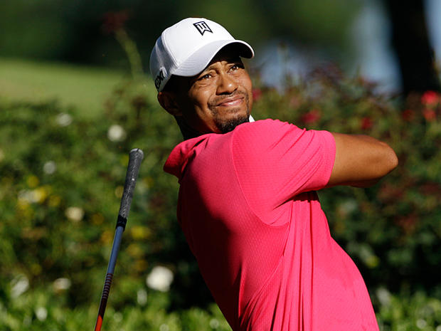 Tiger Woods drops his club after hitting a drive 