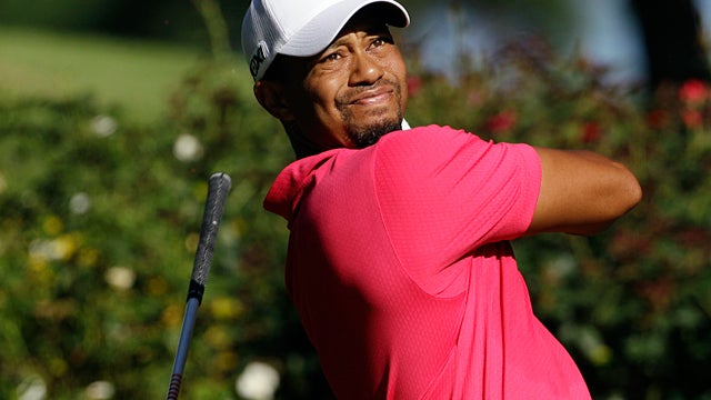 Tiger Woods drops his club after hitting a drive 