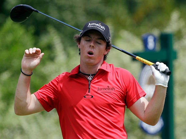 Rory McIlroy reacts after hitting a drive on the fifth tee  
